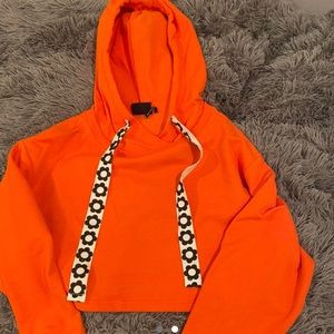 Cropped Urban Outfitters orange sweatshirt with floral stings